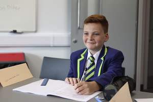Boy smiling at desk